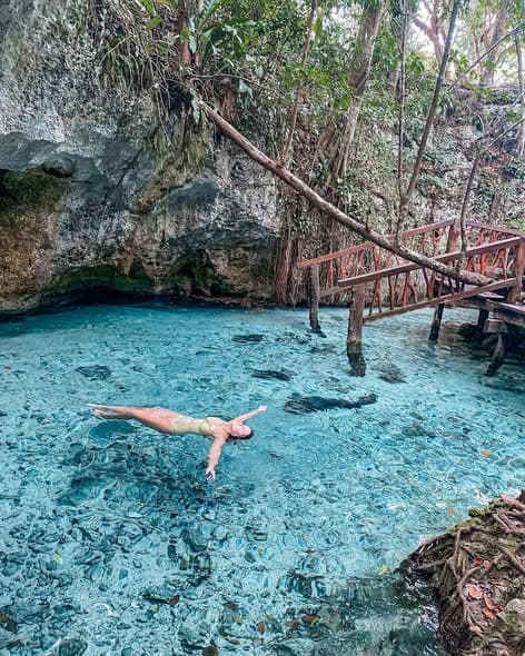 a ladder into clear waters of Gran Cenote in Mexico